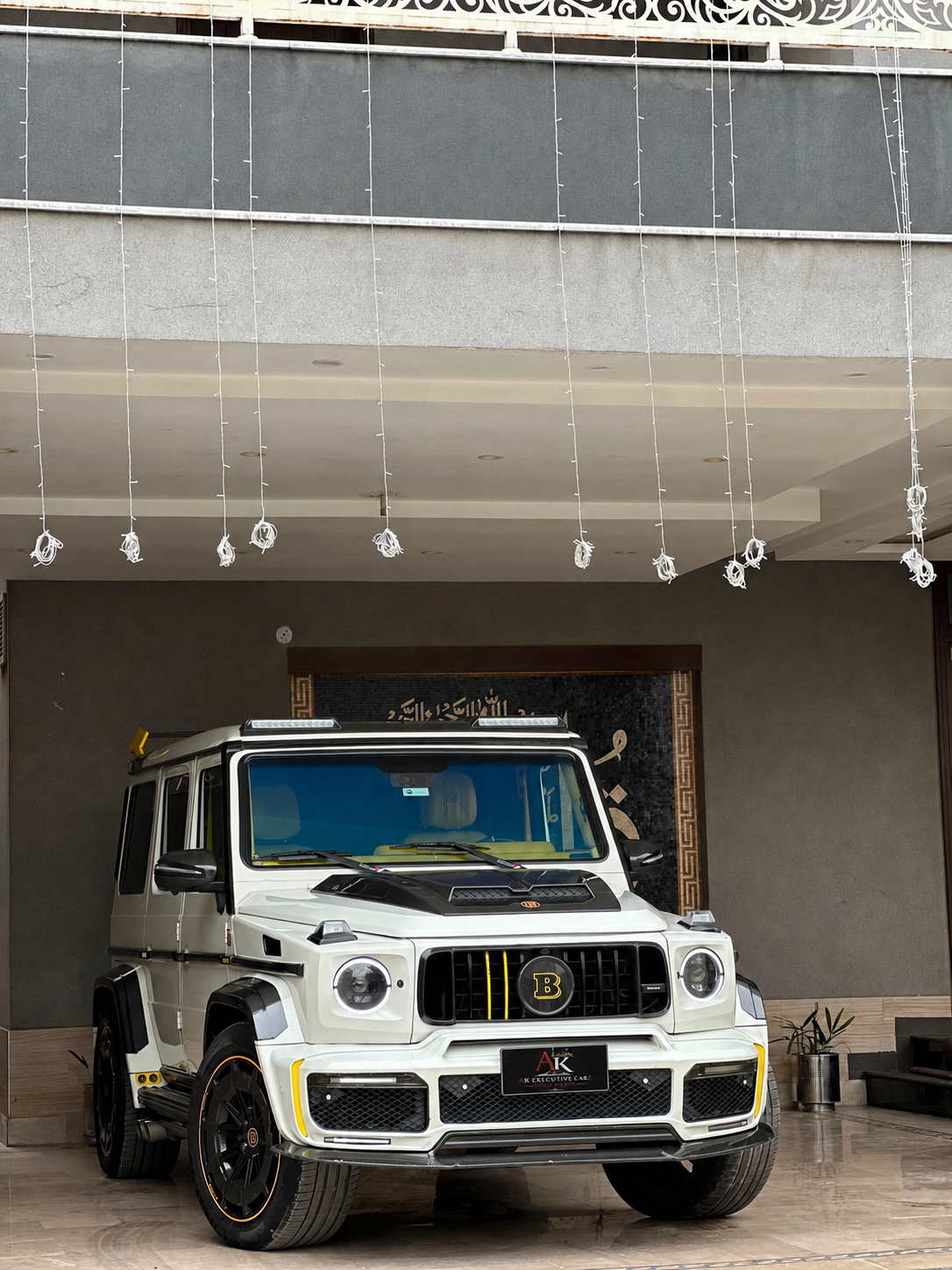 White modified G-Wagon with AK Executive Carz plate